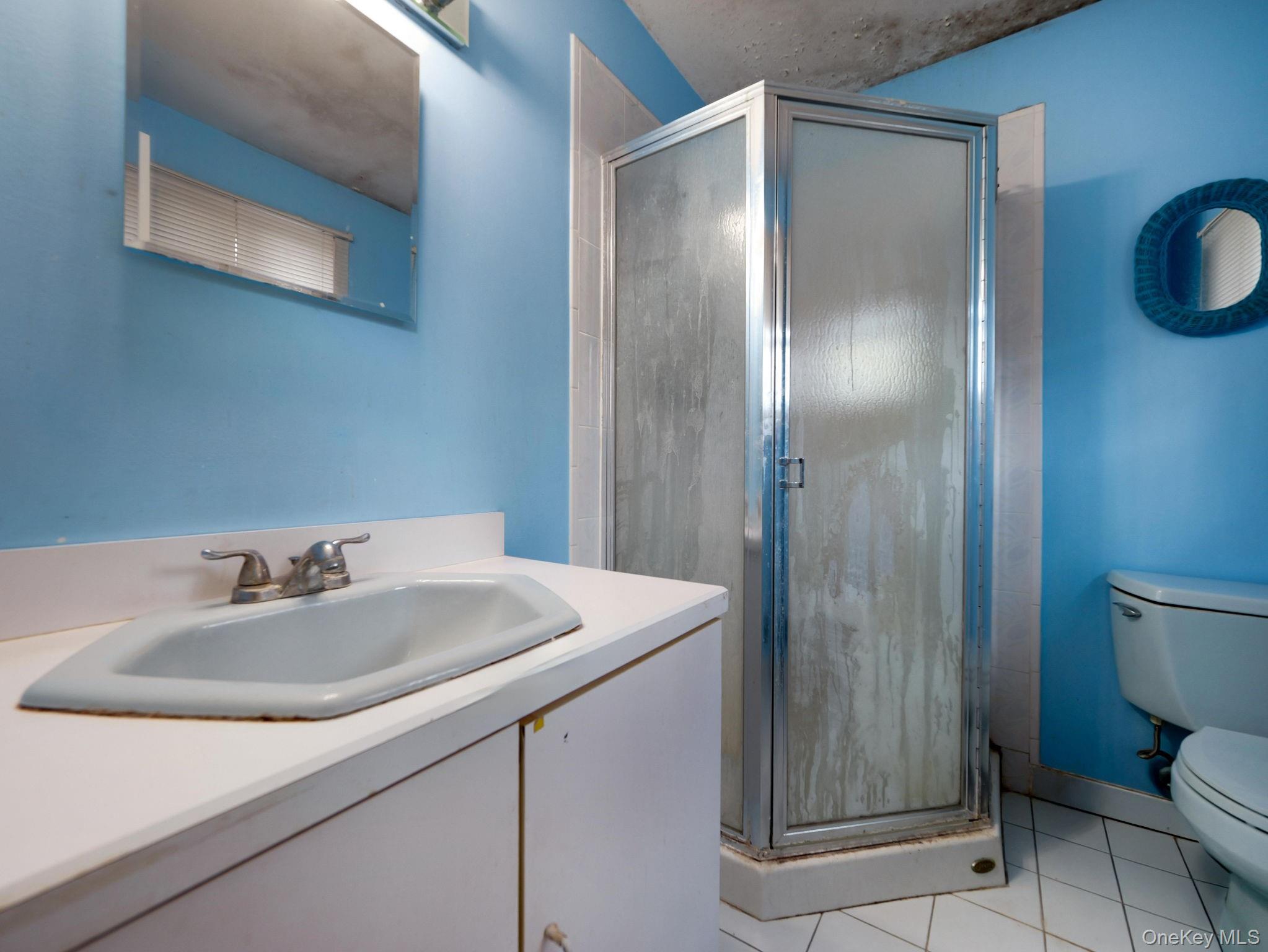 6 Pennington Way Spring Valley, NY 10977 - Photo 17 of 34 Full bathroom featuring light tile patterned floors, vanity, and a shower stall