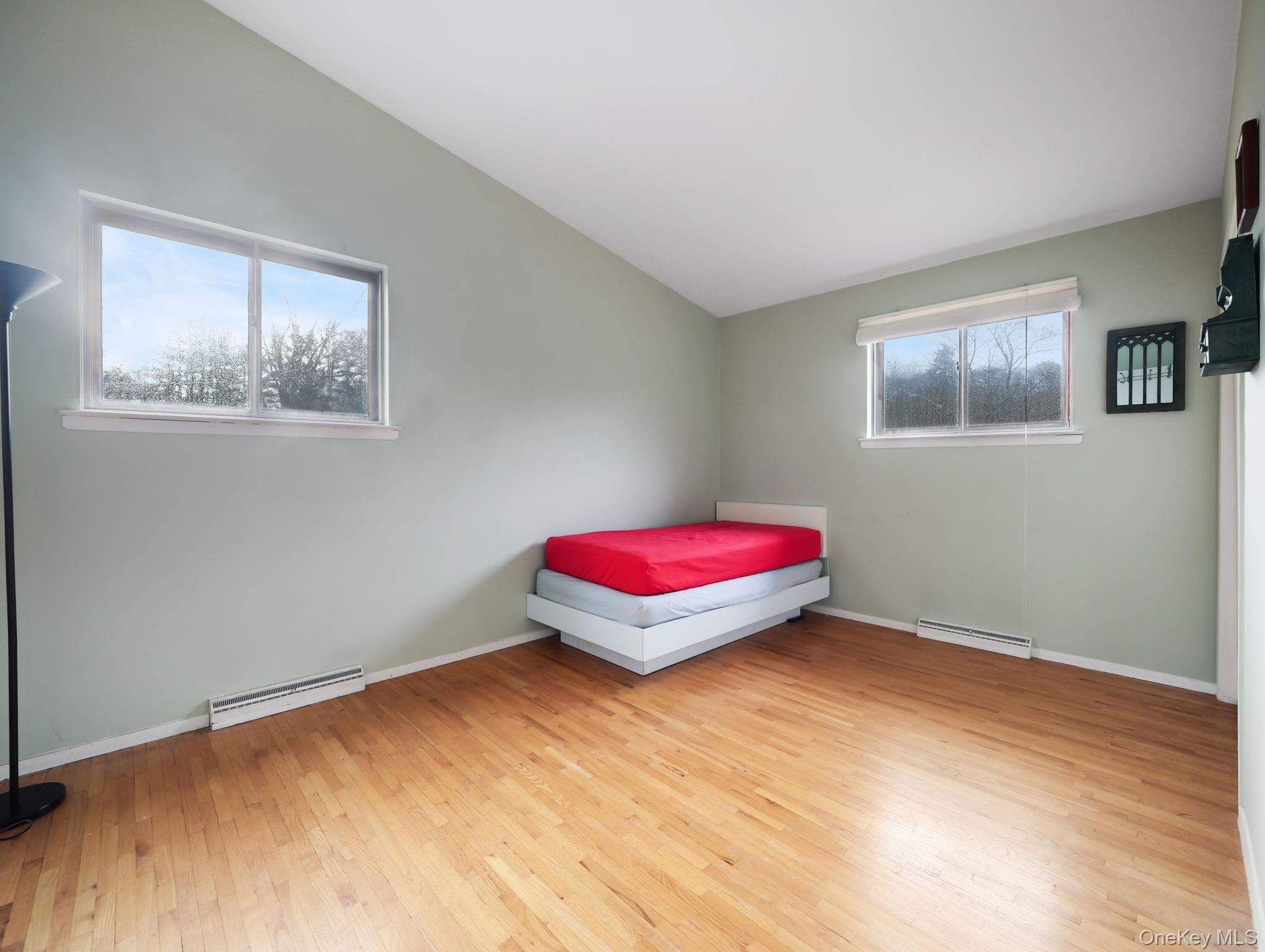 6 Pennington Way Spring Valley, NY 10977 - Photo 21 of 34 Bedroom featuring vaulted ceiling, light wood-type flooring