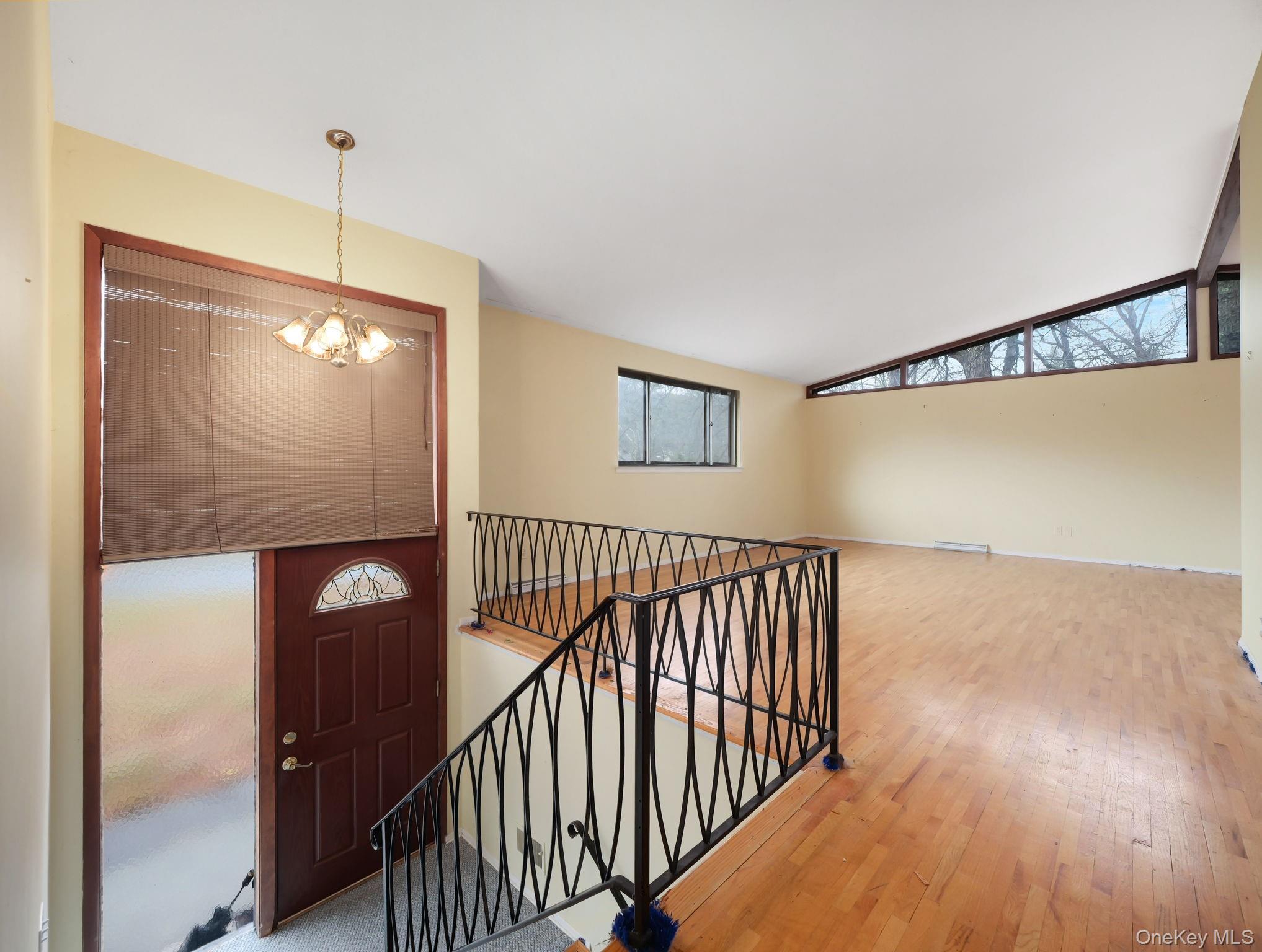 6 Pennington Way Spring Valley, NY 10977 - Photo 7 of 34 Entrance foyer with lofted ceiling, a chandelier, and hardwood flooring