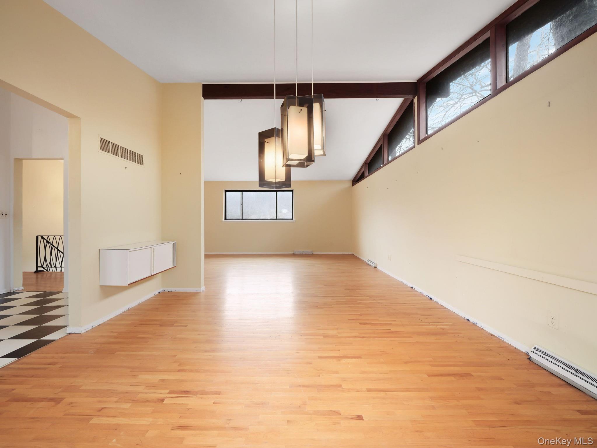 6 Pennington Way Spring Valley, NY 10977 - Photo 9 of 34 Dining area with light wood floors and high vaulted ceiling