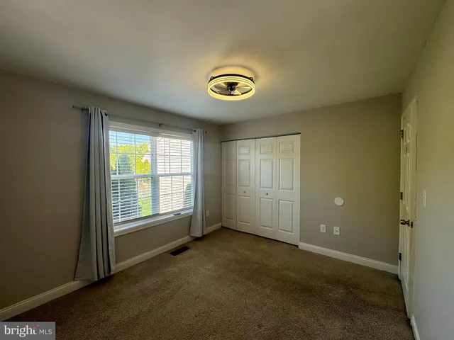 an empty room with closet and window