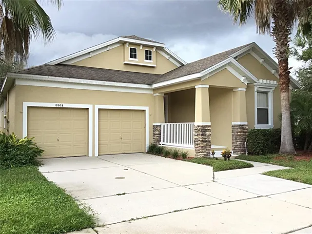 a front view of a house with a yard and garage