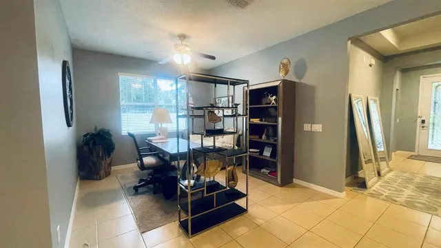 a view of a dining room with furniture and a chandelier