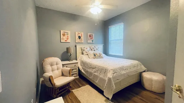 a bedroom with a bed and a chair