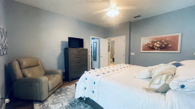 a bedroom with a bed and a couch