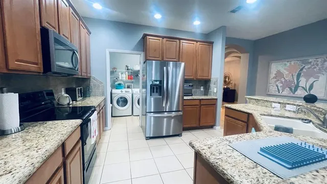 a kitchen with a stove sink and refrigerator