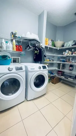a utility room with sink dryer and washer