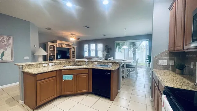a kitchen with granite countertop a sink and cabinets