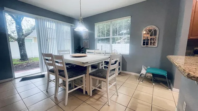 a dining room with furniture and window