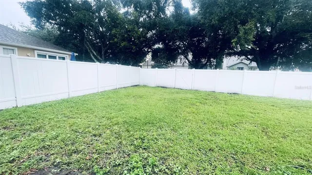 a view of backyard with large trees