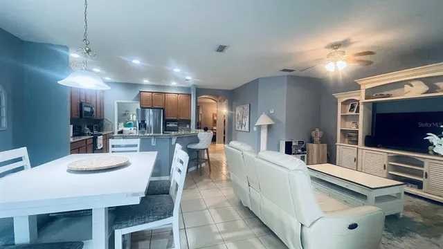a large kitchen with a table and chairs