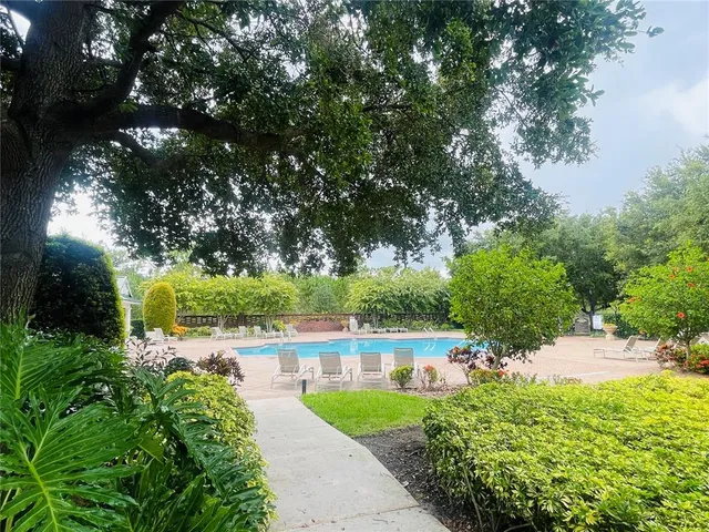 a view of a garden with a house in the background