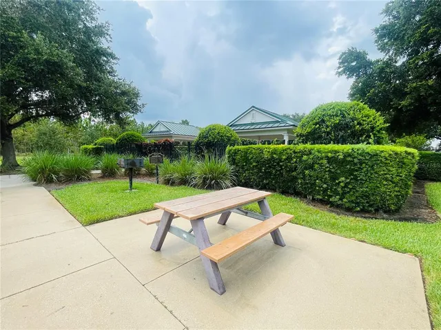 a view of backyard with seating area and green space