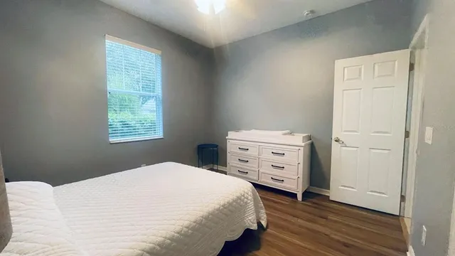 a bedroom with a bed and a window