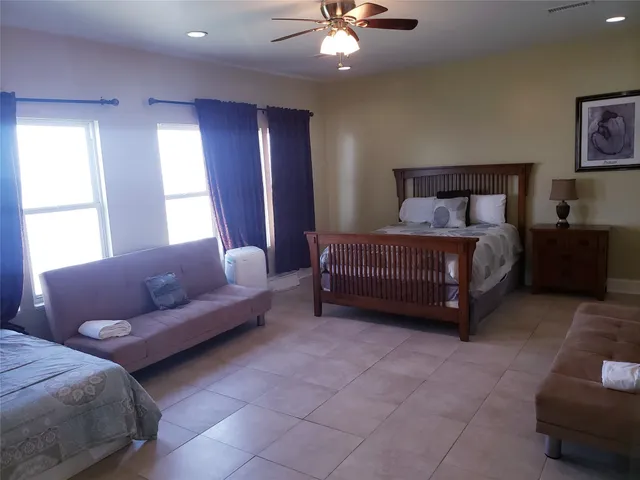 a bedroom with a bed and a large window