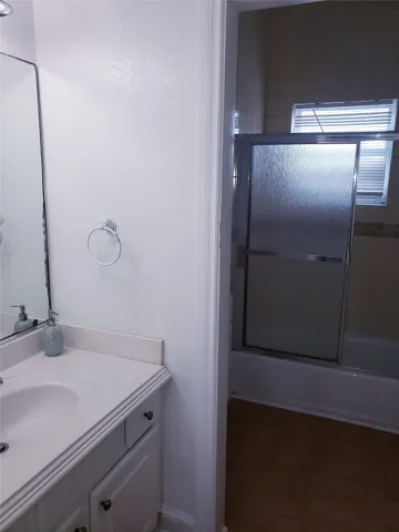 a bathroom with a double vanity sink toilet and shower