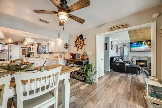 a kitchen with granite countertop white cabinets and stainless steel appliances