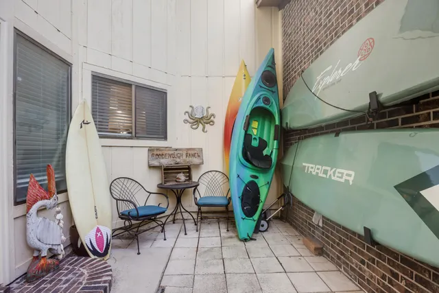 a living room with furniture a large window and flat screen tv