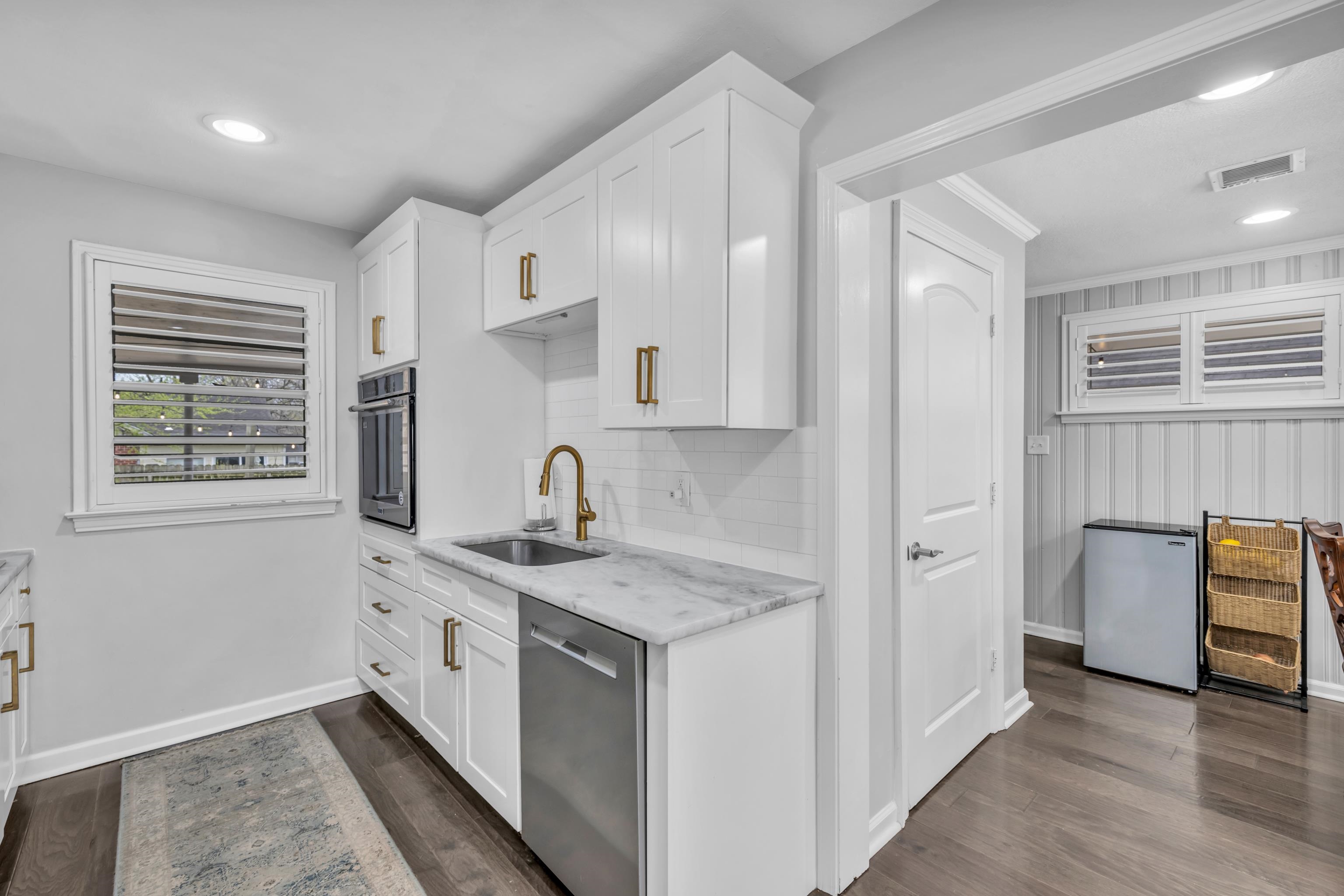 5051 Dee Road Memphis, TN 38117 - Photo 8 of 32 a kitchen with stainless steel appliances granite countertop a sink and dishwasher with wooden floor