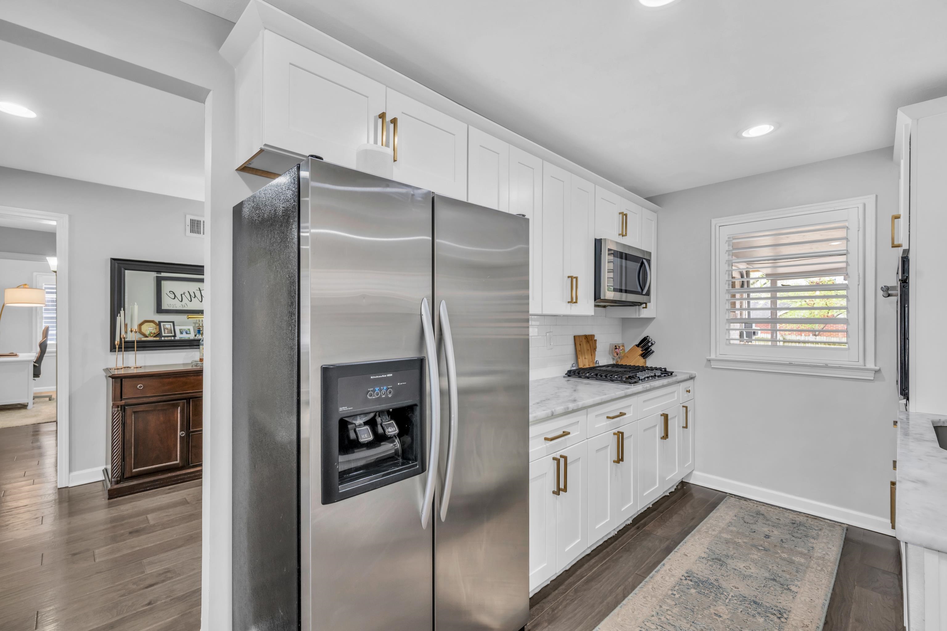 5051 Dee Road Memphis, TN 38117 - Photo 9 of 32 a kitchen with stainless steel appliances a refrigerator a stove and a refrigerator