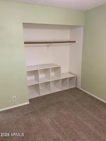 a view of an empty room with empty shelves