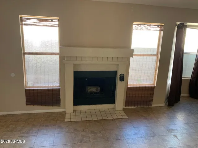 a living room with a fireplace and a rug