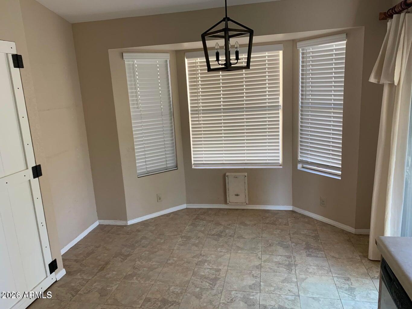 4043 West Camino Del Rio Glendale, AZ 85310 - Photo 5 of 16 a view of an empty room with a window