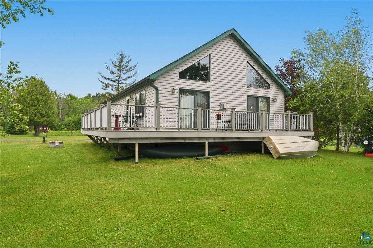 A-frame style residence featuring light gray siding and a green roof