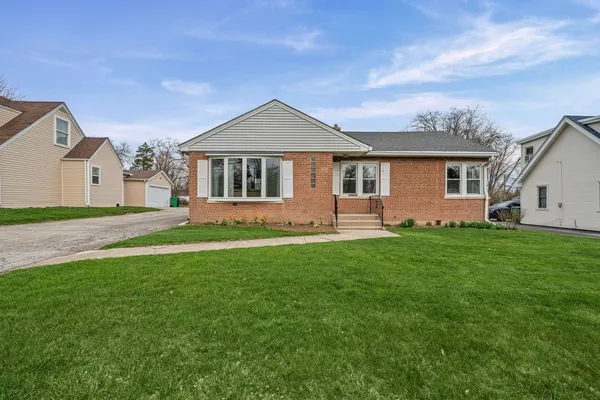 a front view of house with yard and green space