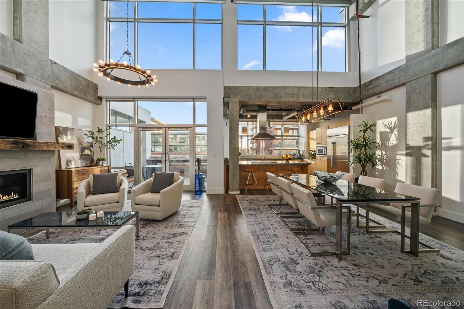 1610 Little Raven Street, Unit PH5 Denver, CO 80202 - Photo 1 of 44 a living room with furniture a fireplace and a flat screen tv