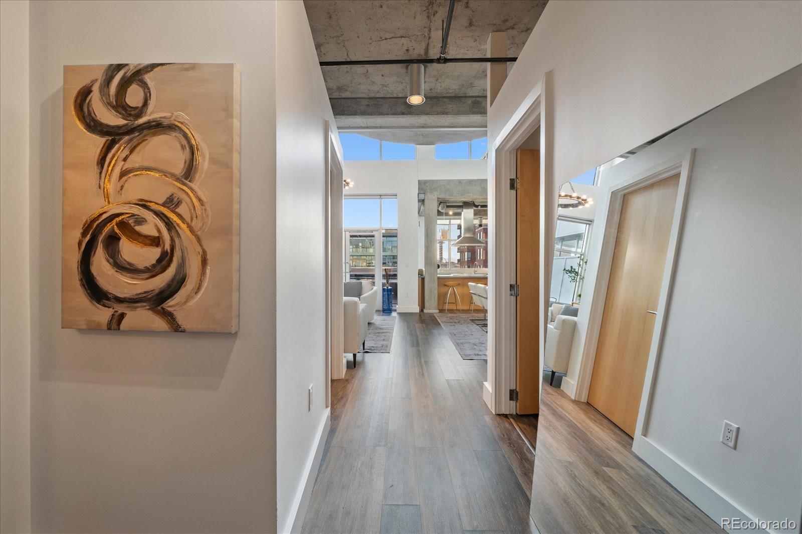1610 Little Raven Street, Unit PH5 Denver, CO 80202 - Photo 24 of 44 a view of a hallway with wooden floor