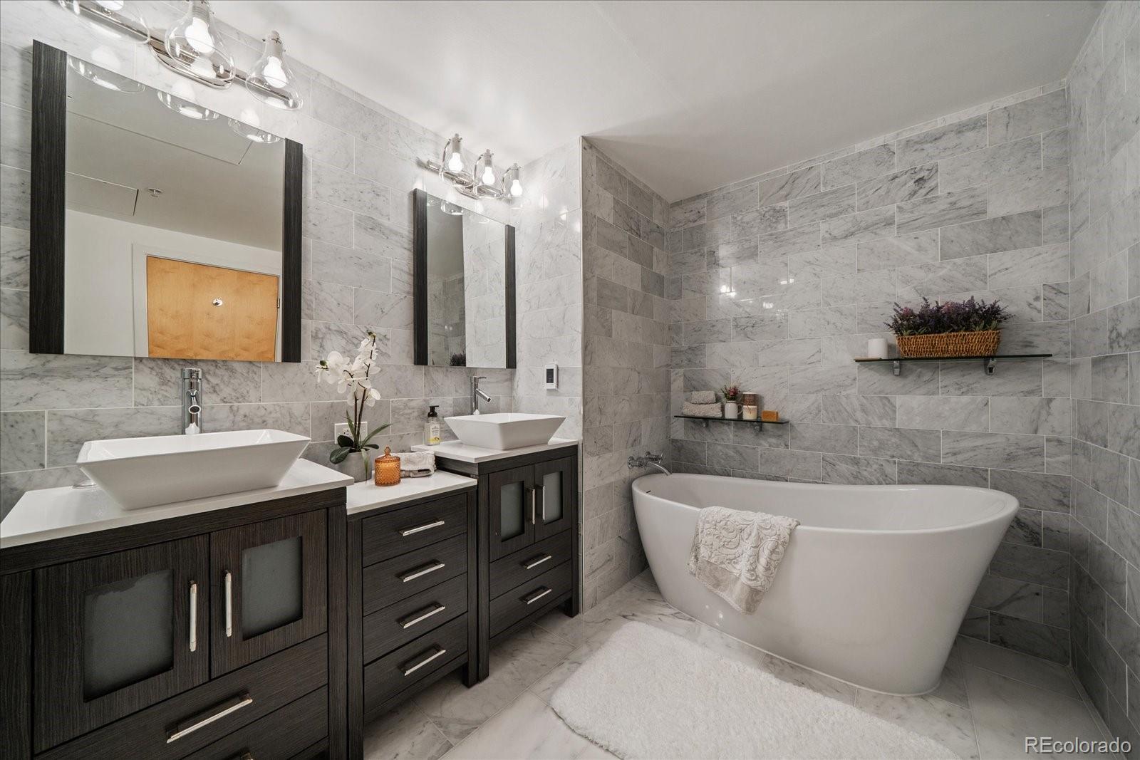 1610 Little Raven Street, Unit PH5 Denver, CO 80202 - Photo 32 of 44 a spacious bathroom with a double vanity sink mirror and bathtub