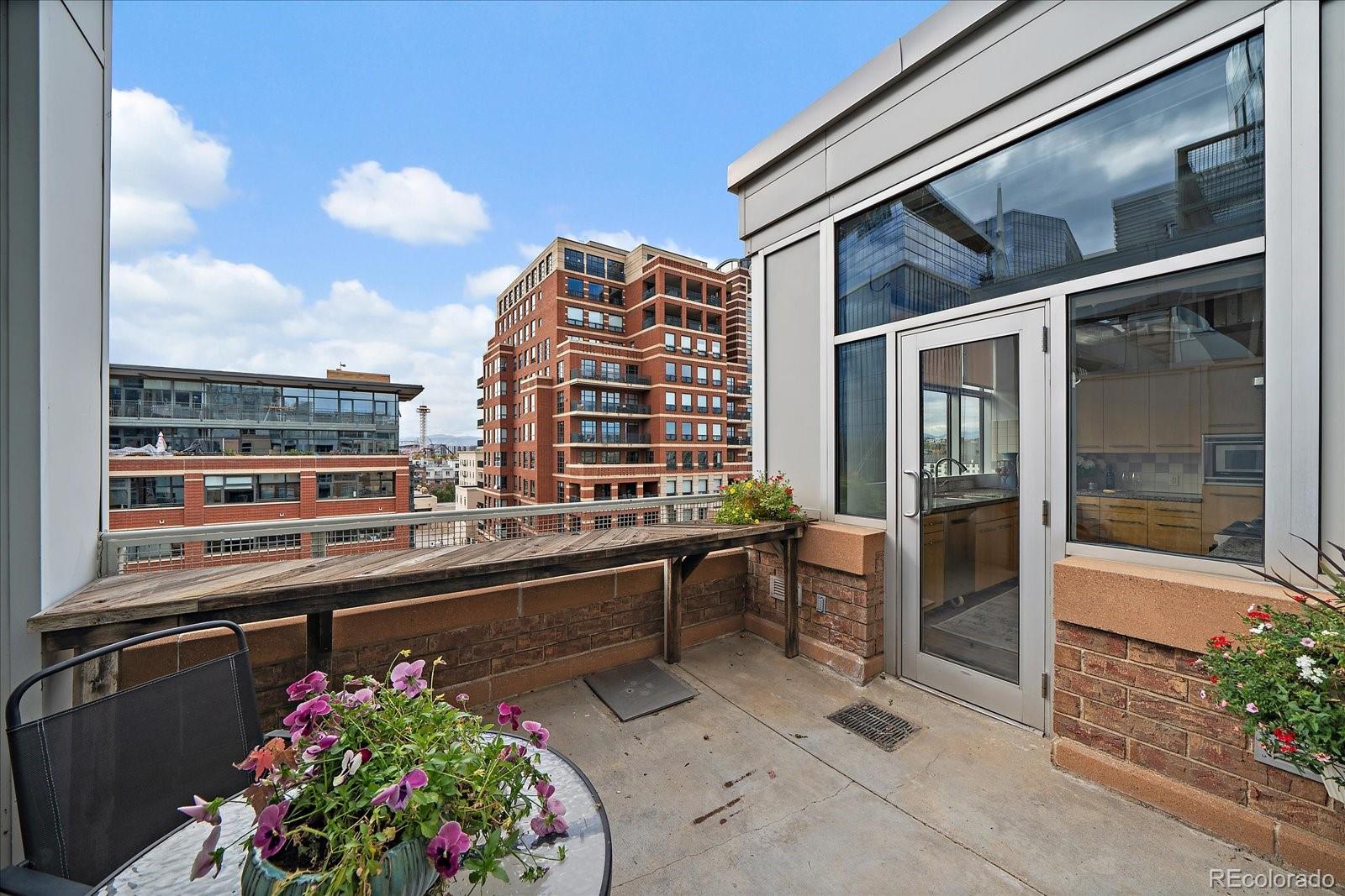 1610 Little Raven Street, Unit PH5 Denver, CO 80202 - Photo 35 of 44 a view of a balcony with chairs potted plants