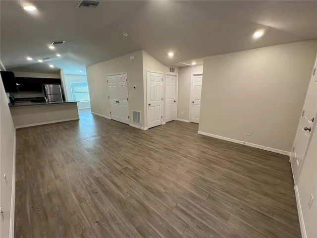 a view of a room with wooden floor