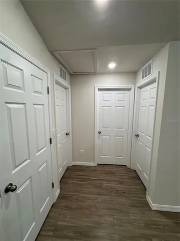 a view of hallway with wooden floor
