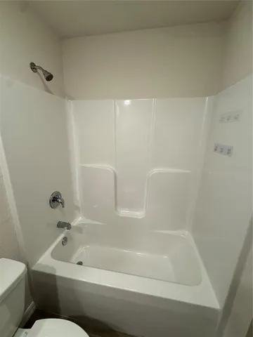 a bathroom with a tub and a shower