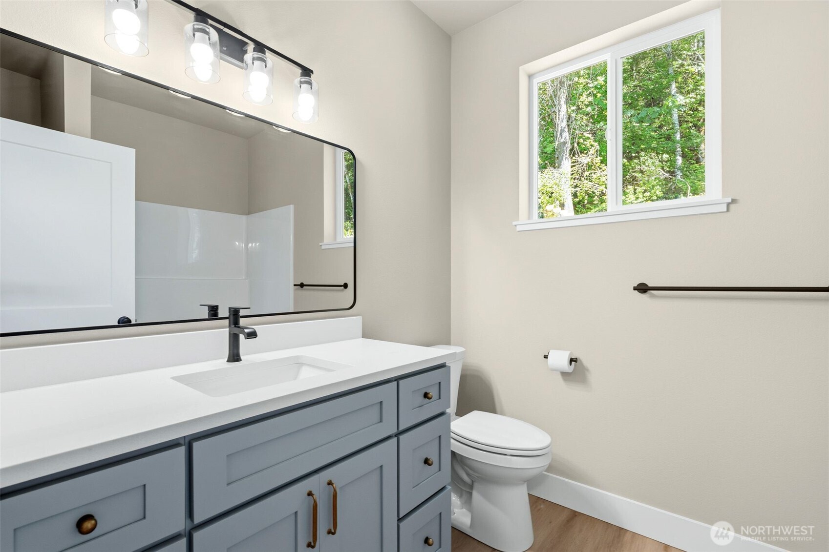 254 Windy Ridge Drive Longview, WA 98632 - Photo 20 of 27 a bathroom with a sink a mirror and a toilet