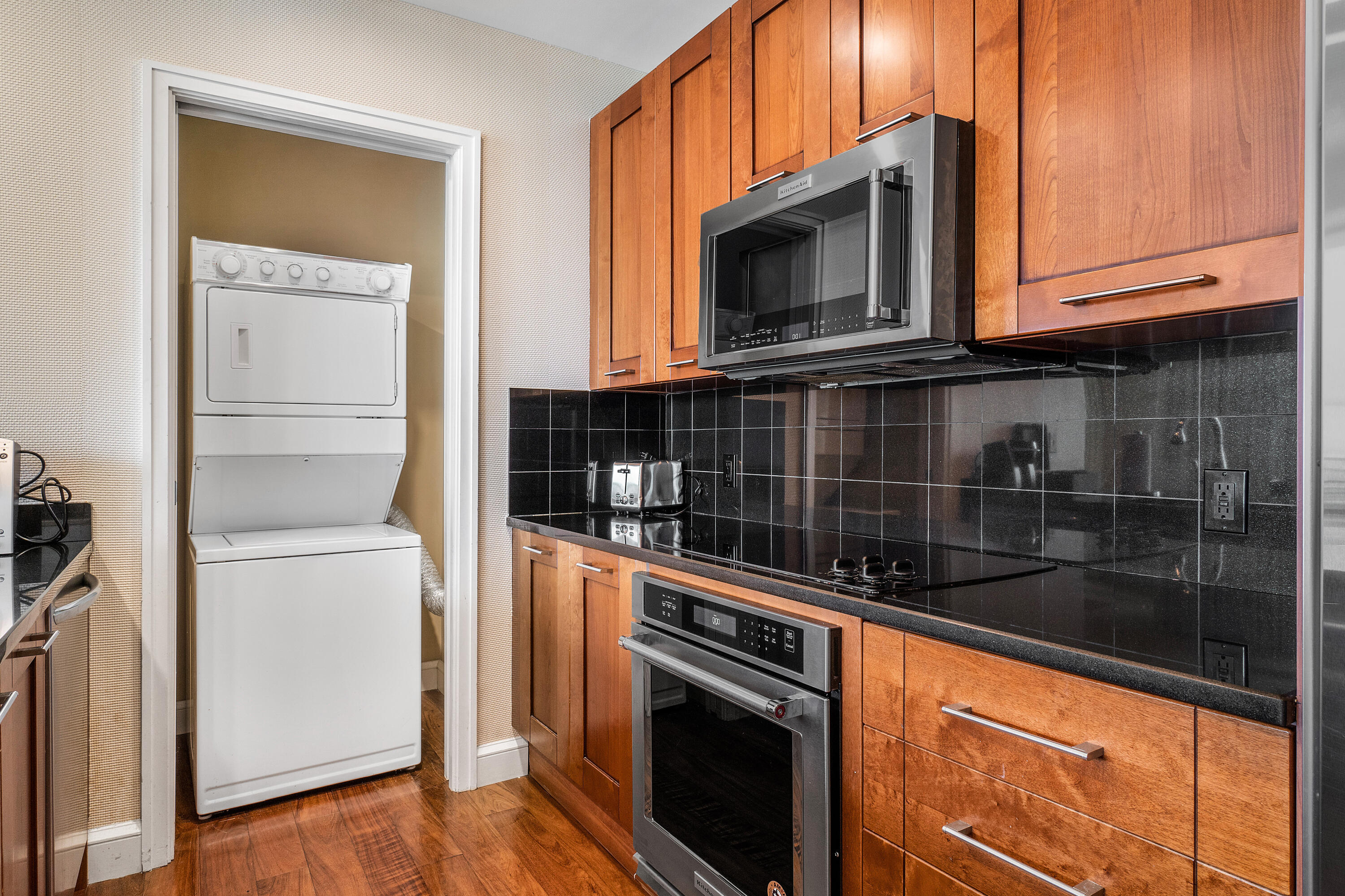 3800 North Ocean Drive Riviera Beach, FL 33404 - Photo 23 of 51 a kitchen with granite countertop a stove and a microwave