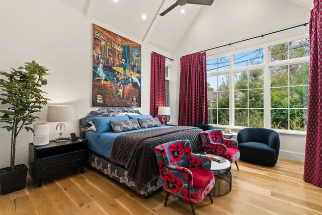 a bedroom with a bed and a window with the outer view