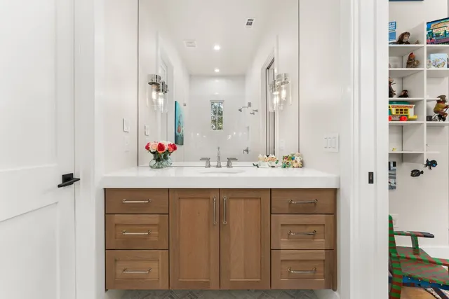 a view of a workspace with furniture and a window