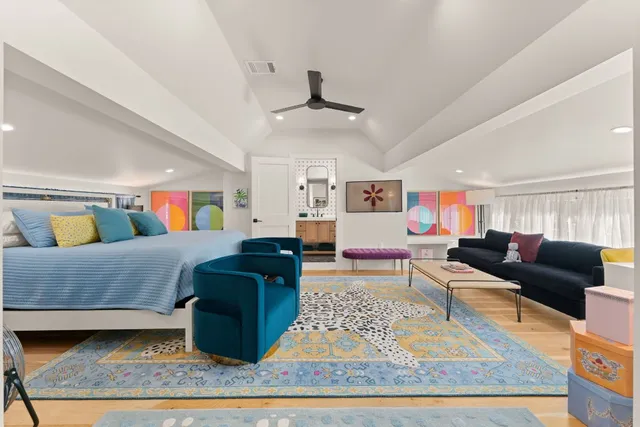 a living room with lots of furniture and kitchen view