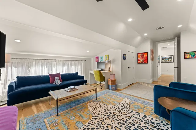 a living room with lots of furniture and a dining table