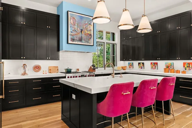 a kitchen with a sink a stove a dining table and chairs