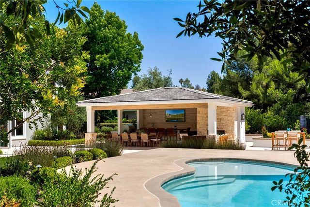 a view of a house with backyard sitting area and garden