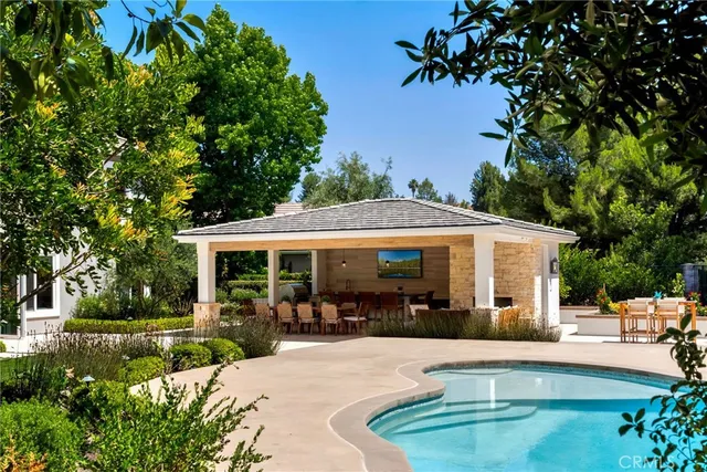 a view of a house with backyard sitting area and garden