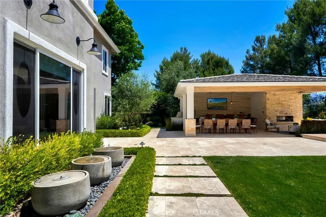 a view of a house with backyard swimming pool and sitting area