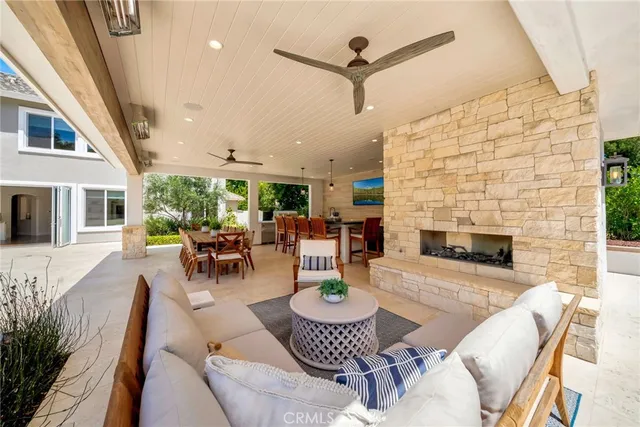 a view of a swimming pool with lawn chairs and a fire pit