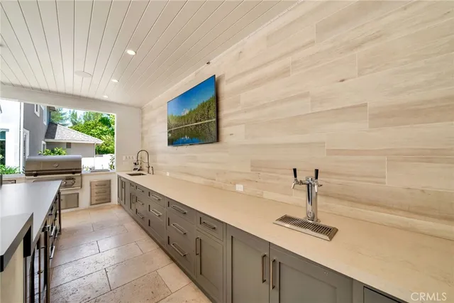 a view of deck with large trees and furniture
