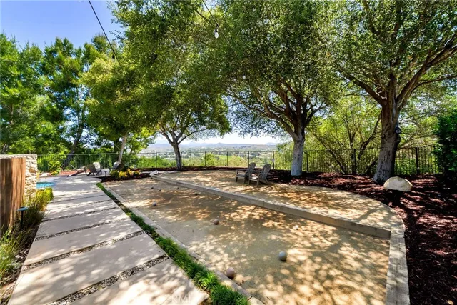 a bathroom with a granite countertop sink mirror vanity and toilet