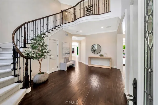 a work room with furniture a chandelier and a large window